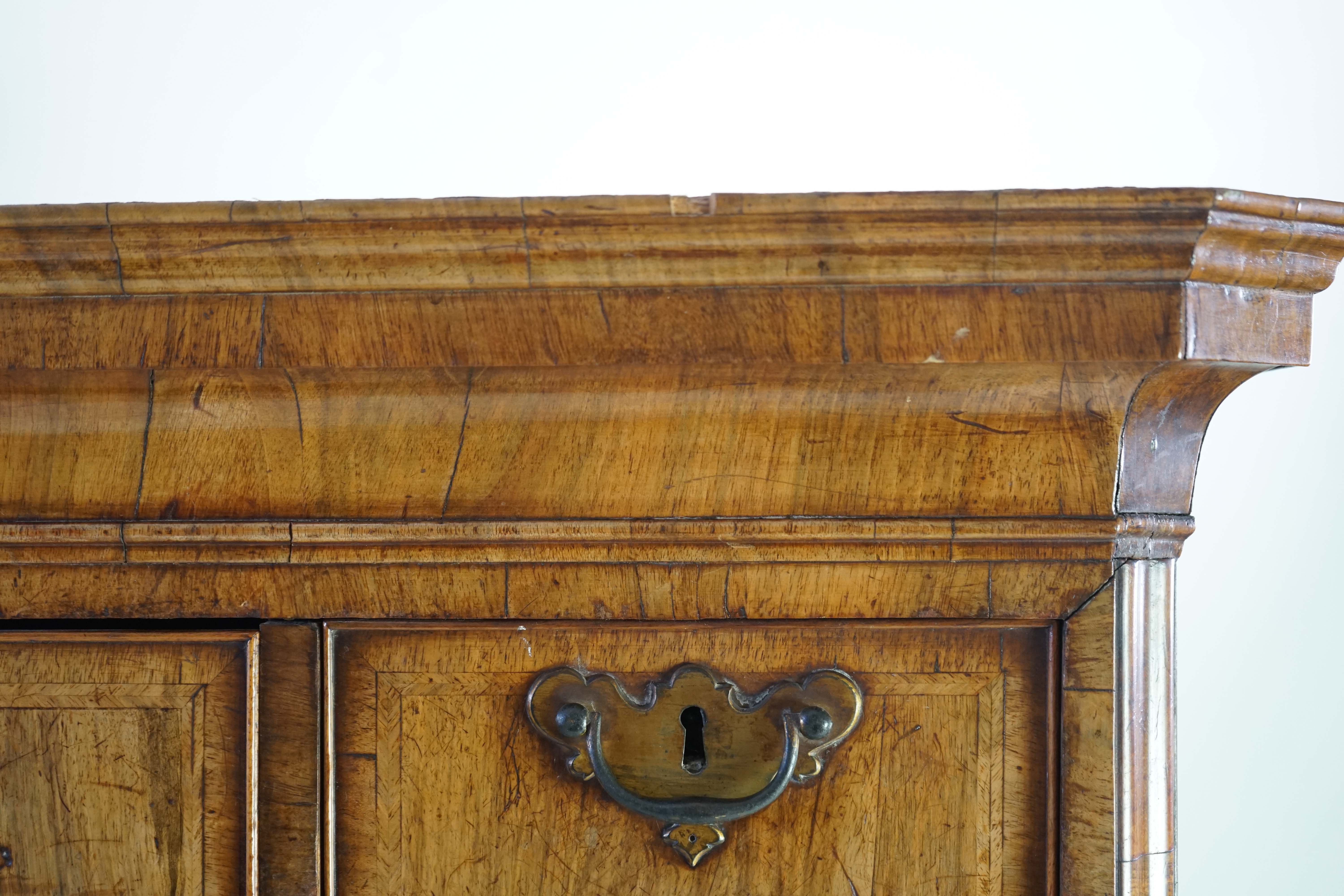 A George II feather banded walnut chest on chest